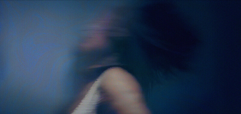 a woman in movement on a blue background